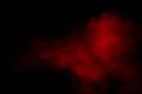Red powder explosion on black background. Freeze motion of red dust particle. Stock Photos