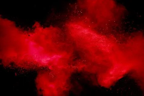 Red powder explosion on black background. Freeze motion of red dust particle. Foto stock