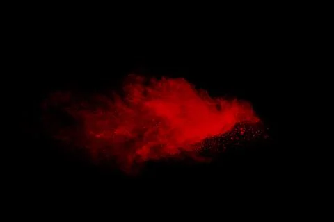Red powder explosion on black background. Stock Photos