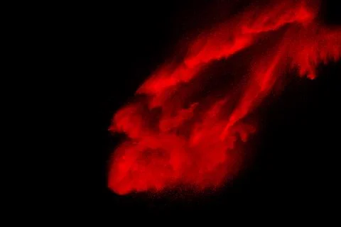 Red powder explosion on black background. Freeze motion of Red dust particl.. Stock Photos
