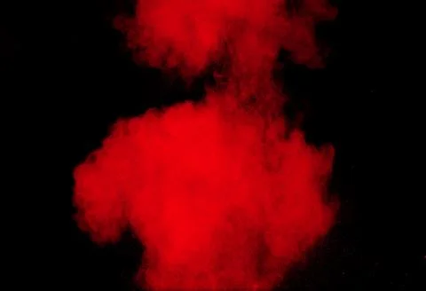 Red powder explosion cloud on black background. Freeze motion of red color. Stock Photos