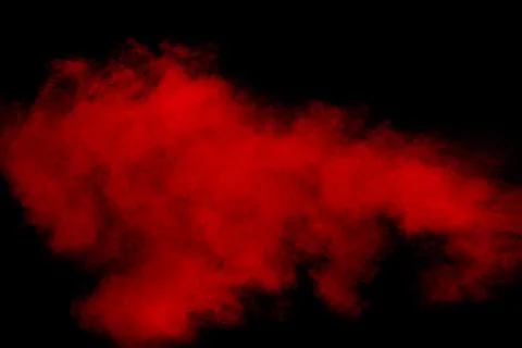 Red powder explosion cloud on black background. Stock Photos