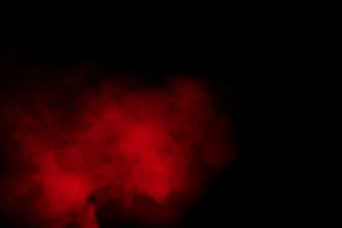 Red powder explosion cloud on black background. Stock Photos