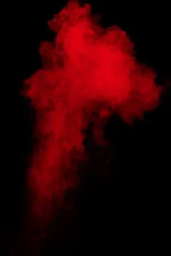 Red powder explosion cloud on black background. Stock Photos