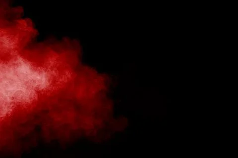 Red powder explosion cloud on black background. Stock Photos