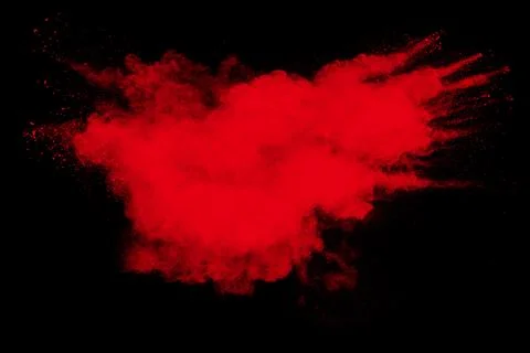 Red powder explosion cloud on black background. Freeze motion of red color. Stock Photos