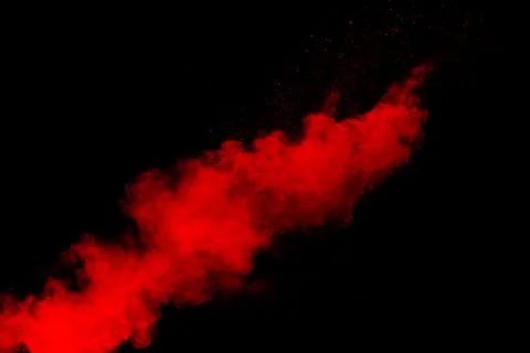 Red powder explosion cloud on black background. Stock Photos