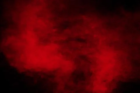 Red powder explosion cloud on black background. Stock Photos