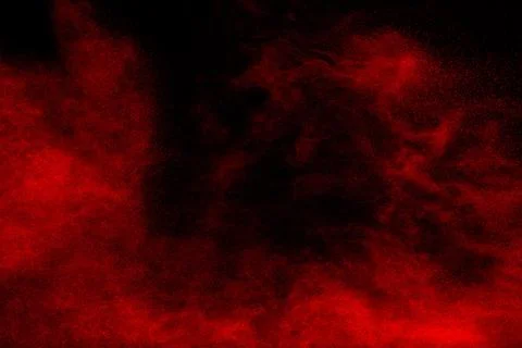 Red powder explosion cloud on black background. Freeze motion of red color .. Stock Photos
