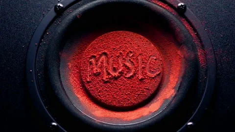 Red powder put on speaker membrane, slow motion Stock Footage 136847453