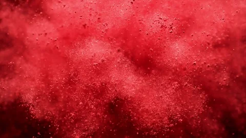 Red powder/particles fly after being exploded. Slow Motion. Stock Footage 84894450