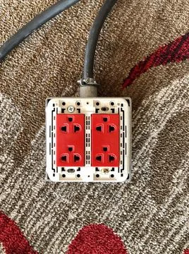 The red power sockets, plug on the floor Stock Photos