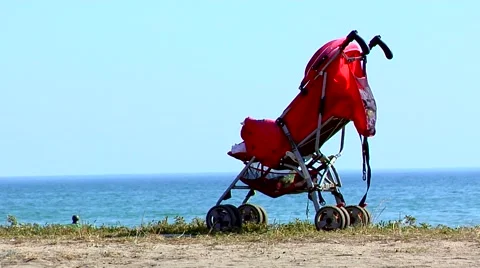 Red pram on the sea Stock Footage 53214078
