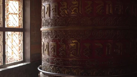 A red prayer wheel with the mantras Stock Footage 107849311