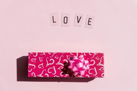 Red present box with bow. Wedding, birthday or Valentines day concept.Love text Stock Photos