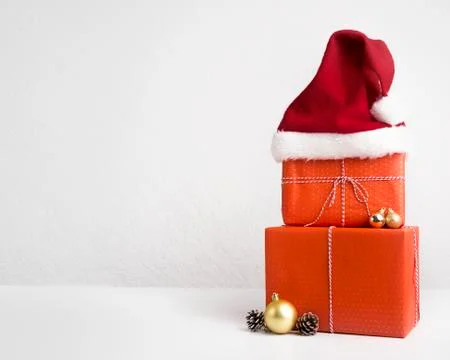 Red Present boxes with Santa's hat on white Stock Photos