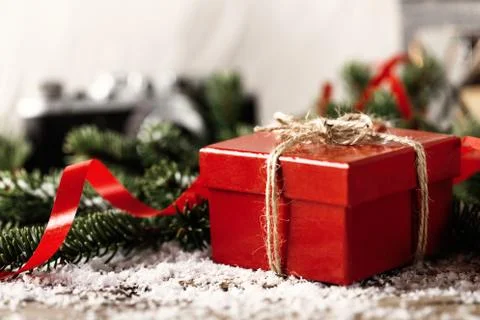 Red present gift box with camera and candle holder on wooden background Chris Stock Photos