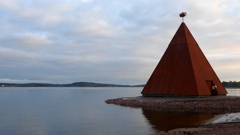 Red pyramid shaped day marker in restored Maritime Quarter of Mariehamn near sea Stock Footage 88882584