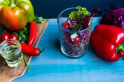 Red quinoa salad with tomato on a rustic table. Superfood and healthy eating  Stock Photos