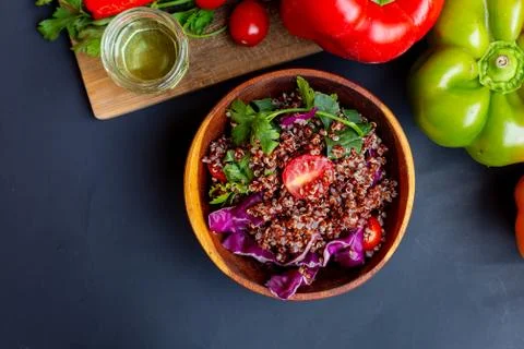 Red quinoa salad with tomato on a rustic table. Superfood and healthy eating  Stock Photos