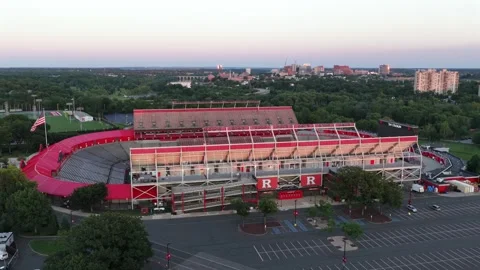 Red R logos mark stadium exterior beside empty parking lot in New Brunswick Stock Footage 340970242