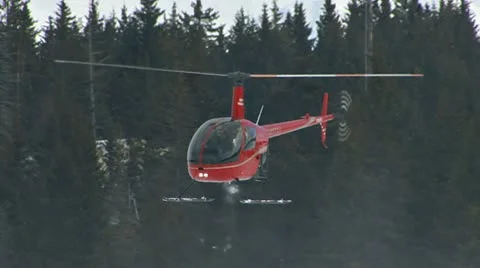 Red R22 Helicopter Hovering in Snowy Forest Stock Footage 10841232