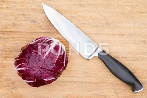 Red radicchio with a kitchen knife Stock-Fotos