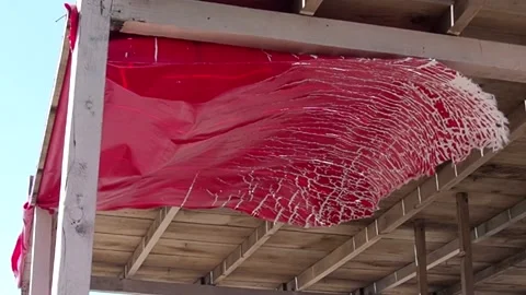 Red rag fluttering in the wind. Abandoned place. An old market stall on the beac Stock Footage 202191520