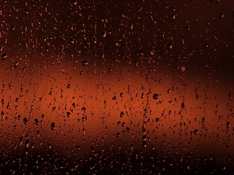 Red rain drops on window Stock Footage 76677576