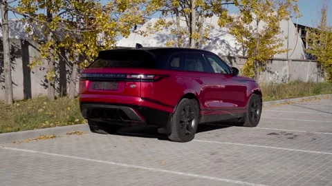 Red Range Rover Velar. Standing in the parking lot Stock Footage 254815940
