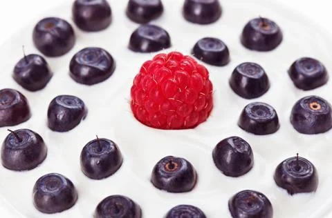 Red raspberry and blue bilberry with sour cream, food background 스톡 사진