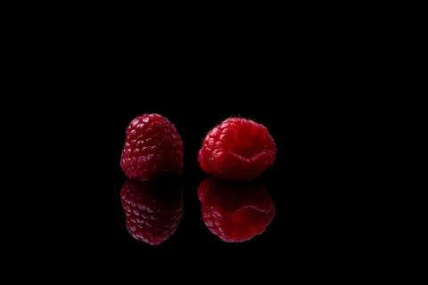 Red raspberry on black background Stock Photos