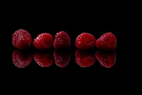 Red raspberry on black background Foto stock