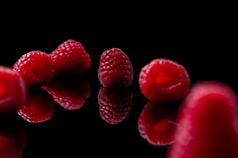 Red raspberry on black background Stock Photos