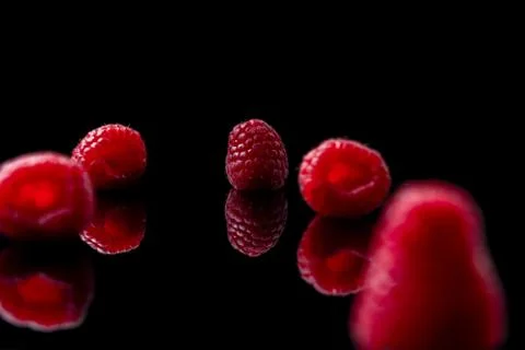 Red raspberry on black background Stock Photos