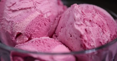 Red raspberry ice cream in a glass bowl on a black background, delicious sweet Stock Footage 300421315