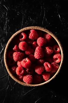 Red raspberry in a plate on a dark background. Fruit berries background. View fr Stock Photos