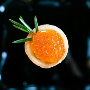 Red raspberry-shaped caviar Stock Photos