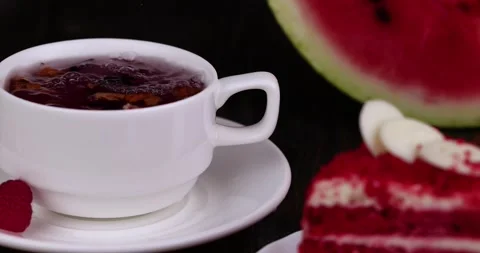 Red raspberry tea with pieces of fruit and berries Stock Footage 211262574