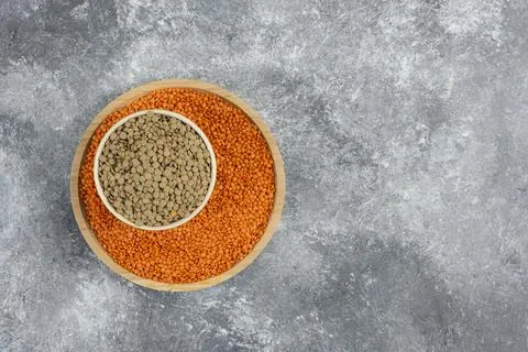 Red raw lentils and split peas on marble background Stock Photos