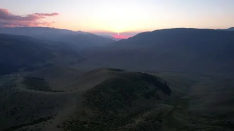 Red rays of the sun at sunset among the mountains Video stock 205085736