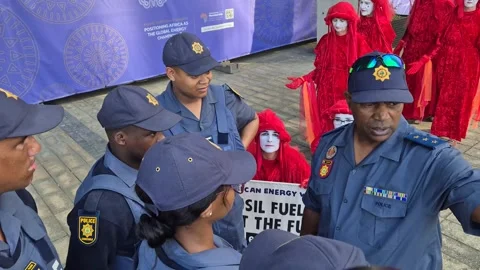 Red Rebel Brigade Silent Protest at African Energy Week, Cape Town 2025 Stock Footage 337914034