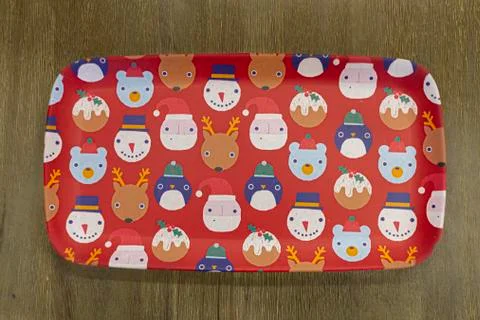 A red rectangular Christmas themed plate on wooden background Stock Photos