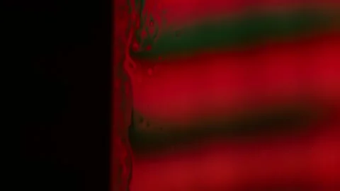 Red reflections of liquid in macro, dark horror background Stock Footage 279861042