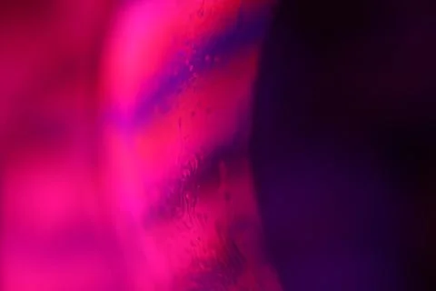 Red reflections of liquid in macro, red surface Stock Photos