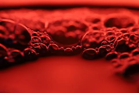 Red reflections of liquid in macro, red surface 写真素材