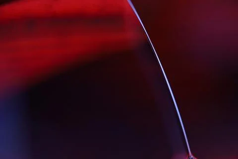 Red reflections of liquid in macro, red surface Stock Photos