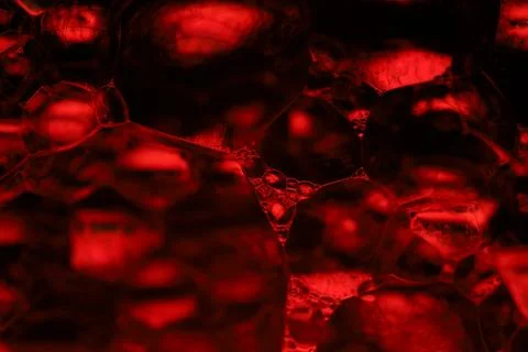 Red reflections of liquid in macro, red geometric shapes Stock Photos