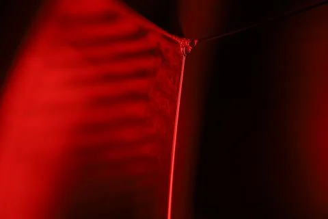 Red reflections of liquid in macro, red geometric shapes Stock Photos