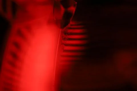 Red reflections of liquid in macro, red geometric shapes Stock Photos